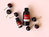 fragrance2U bottles with cherries on a pink background