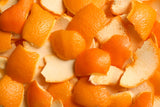 A pile of brightly colored orange peels that could be used for upcycled fragrance ingredients