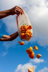 Throwing away orange peels which could be used in upcycled fragrance ingredients