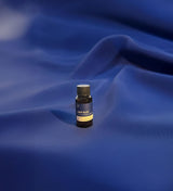 Small bottle labeled 'Deep Blue' on a blue fabric background