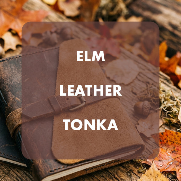 A brown elm leather notebook cover or journal strap shown on a rustic wooden surface with scattered autumn leaves. A translucent dark overlay with the text 'ELM LEATHER TONKA' is centered over the product.