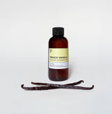 Bottle of French Vanilla with vanilla beans on a white background