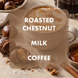 A cup of roasted chestnut milk coffee with creamy latte art, surrounded by whole and cracked chestnuts, a cinnamon stick, and a small bowl of caramel on a beige tabletop. Large white text reads 'ROASTED CHESTNUT MILK COFFEE' over a semi-transparent brown overlay.