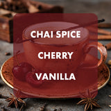 A cup of chai spice latte with cherry pieces and vanilla bean visible, overlaid with a large translucent red label reading 'CHAI SPICE CHERRY VANILLA' on a rustic tabletop with cinnamon sticks and star anise.