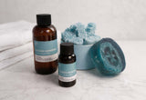 Two bottles labeled 'Ocean Minerals' with a loofah and bath sponge on a light background.