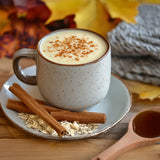 a mug of creamy oat milk with cinnamon dust