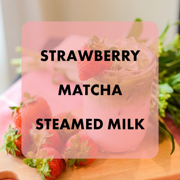 Strawberry Matcha Steamed Milk with strawberries on a wooden surface