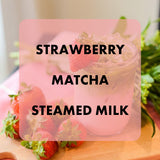 Strawberry Matcha Steamed Milk with strawberries on a wooden surface